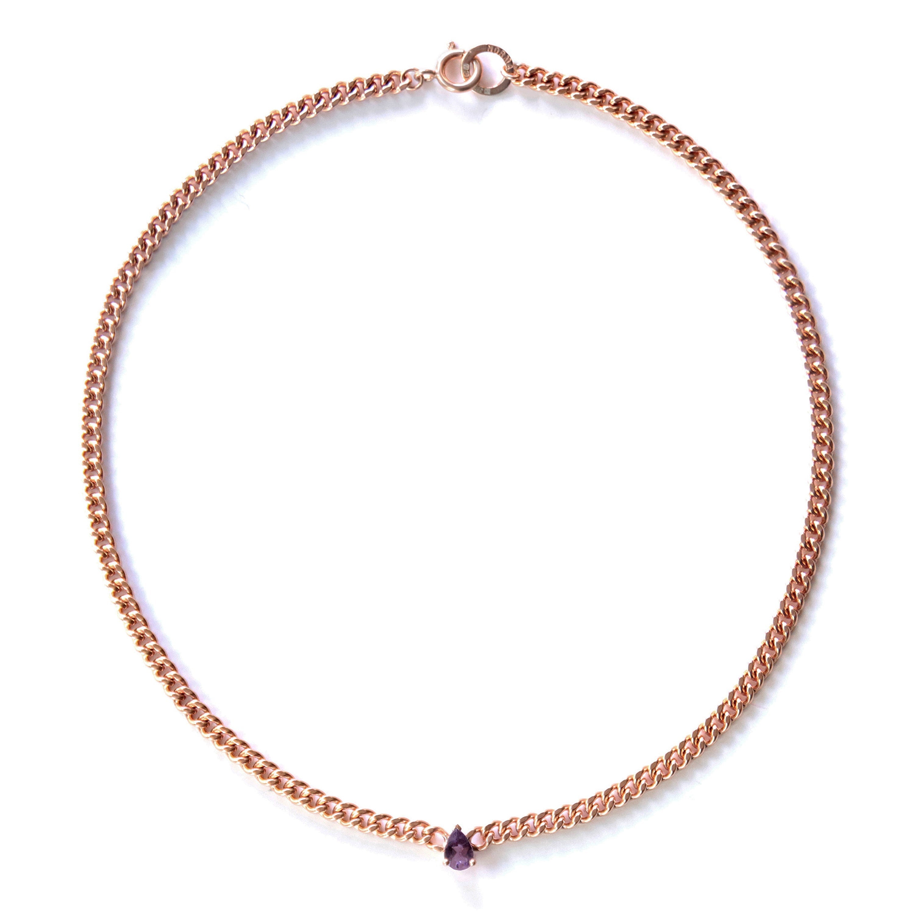 Rose gold necklace with an amethyst gemstone on a white background