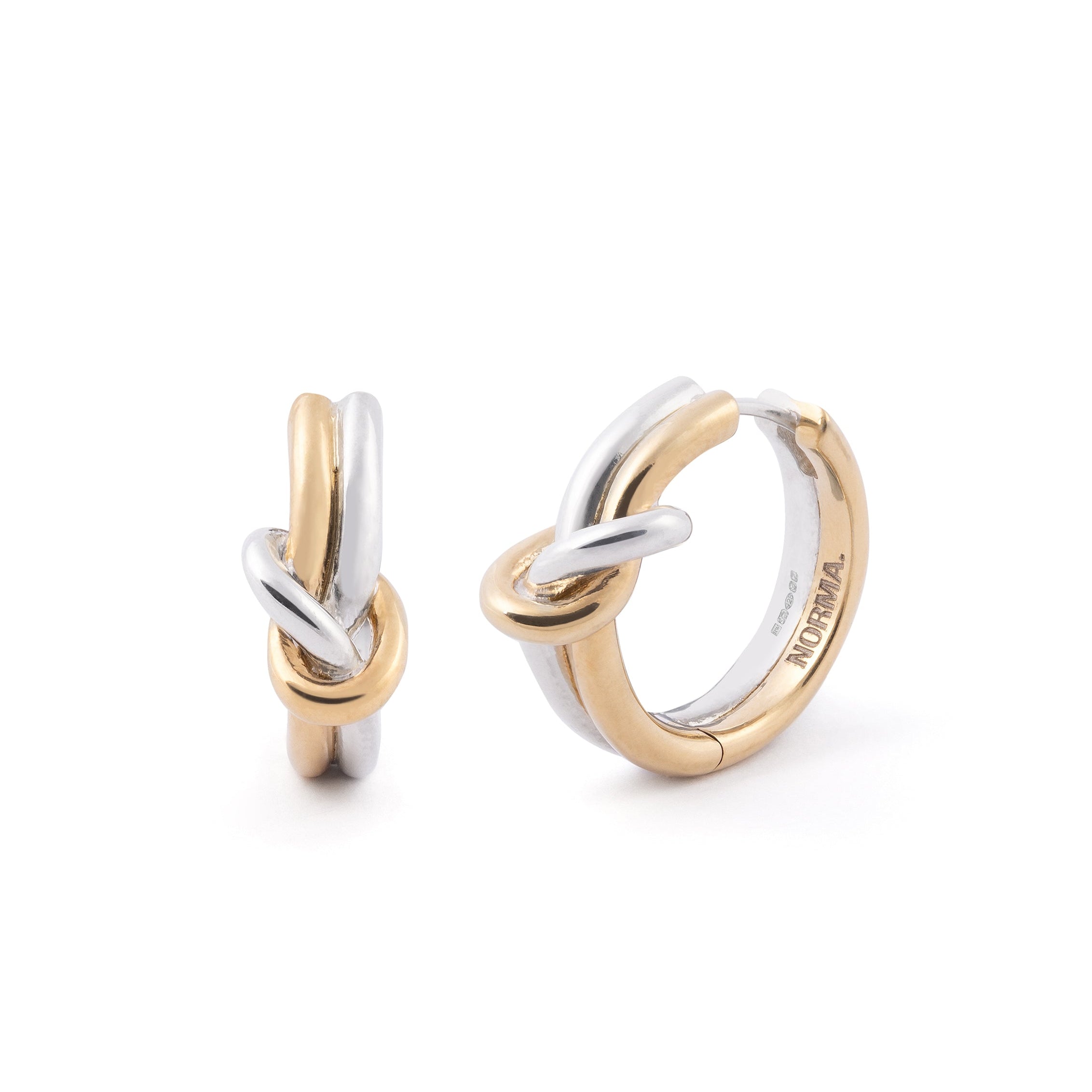 Two gold and silver earrings on a white background