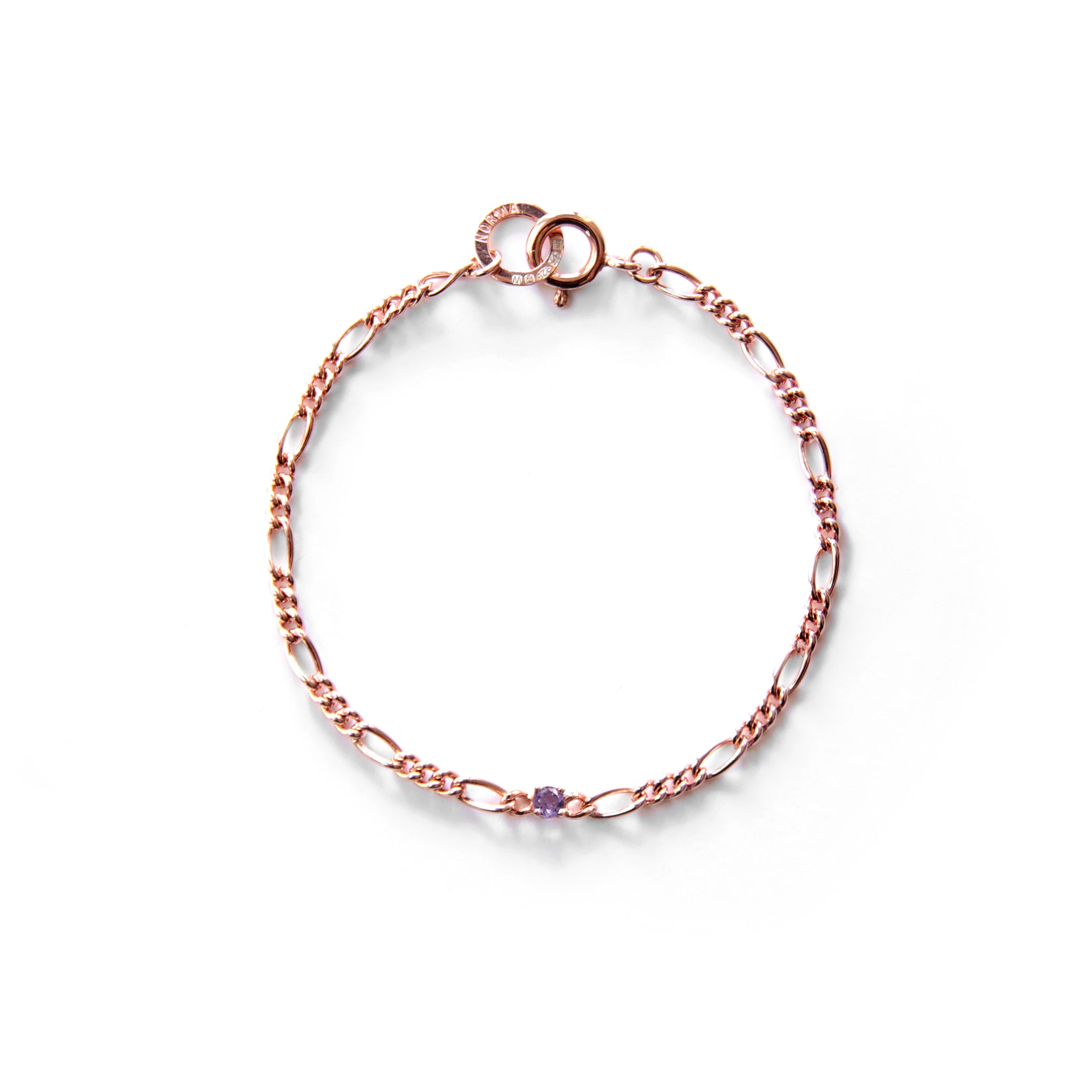 Rose gold bracelet with a small amethyst gemstone on a white background