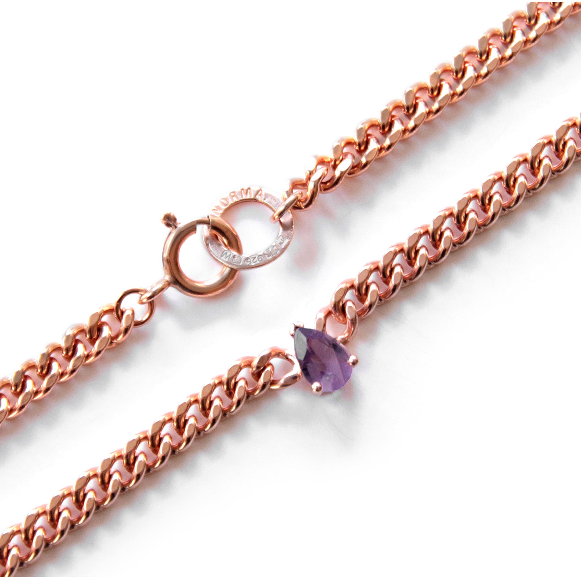 Rose gold chain necklace with an amethyst gemstone on a white background