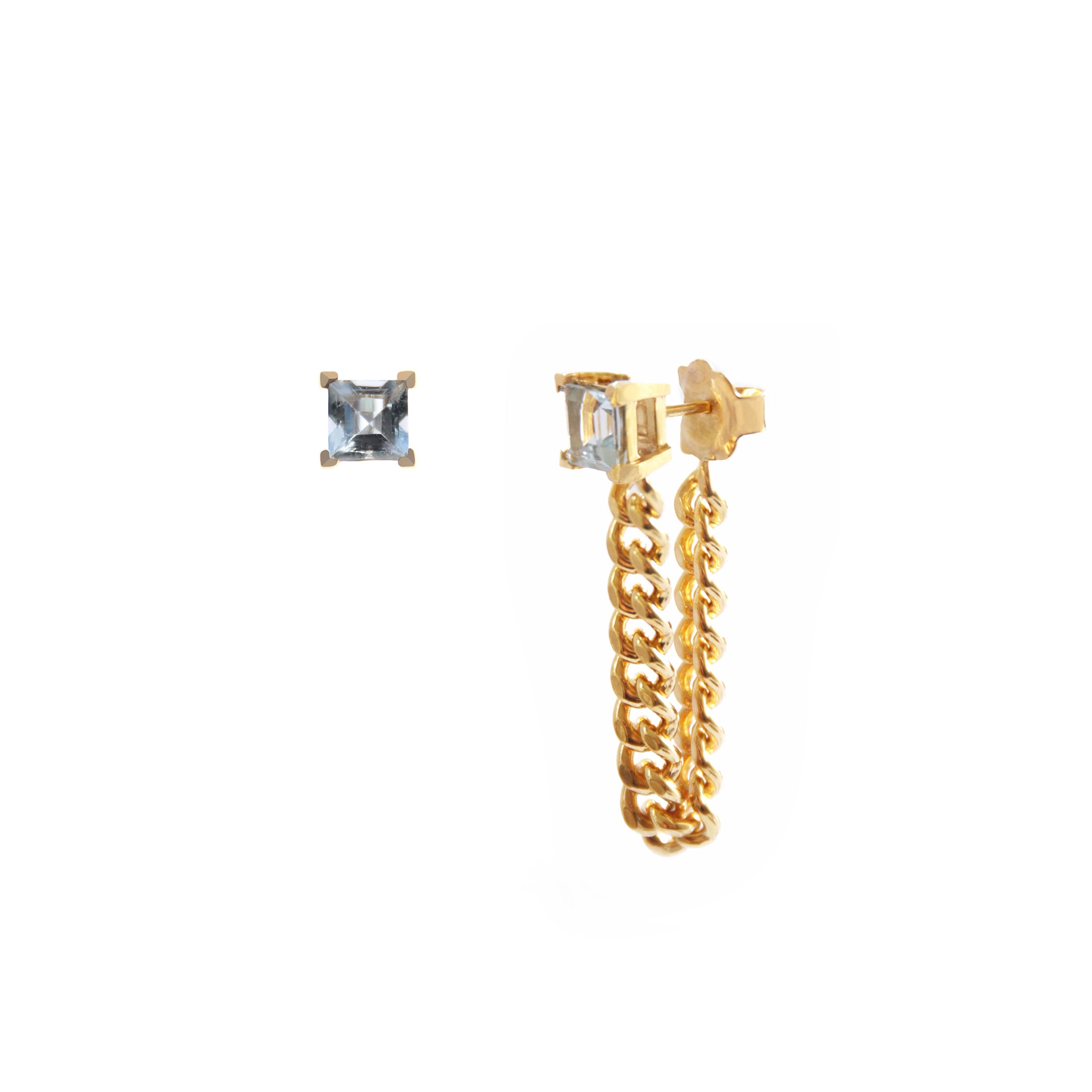 Gold chain earring and aquamarine stud earring on a white background